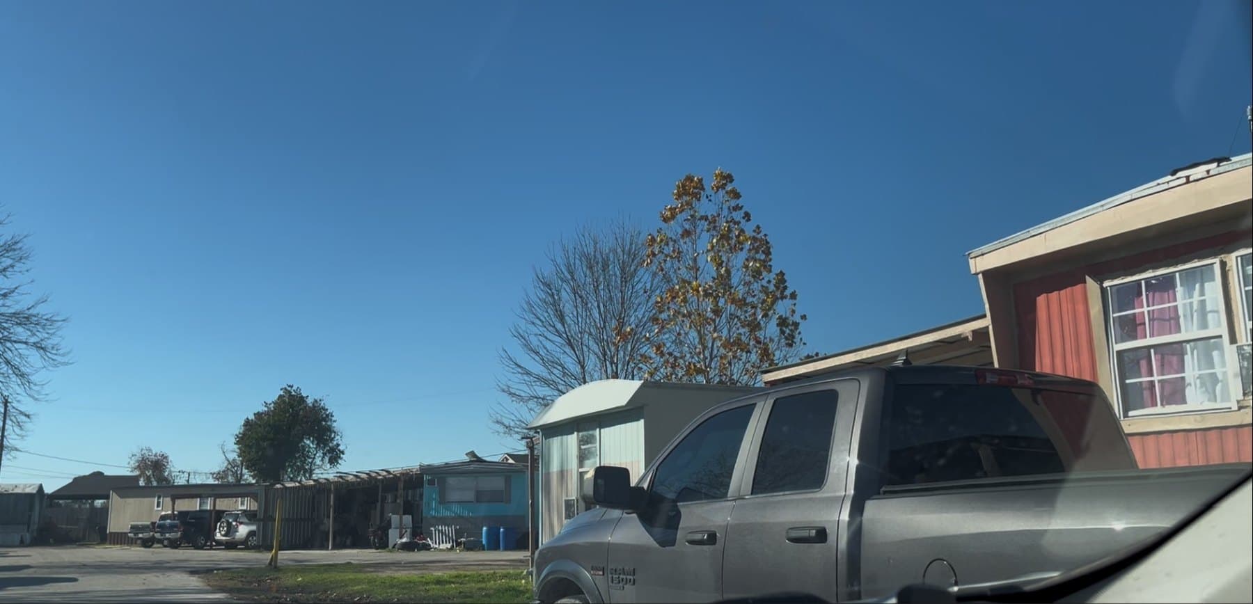 Mobile home and parking area at Woodforest Mobile Home Park