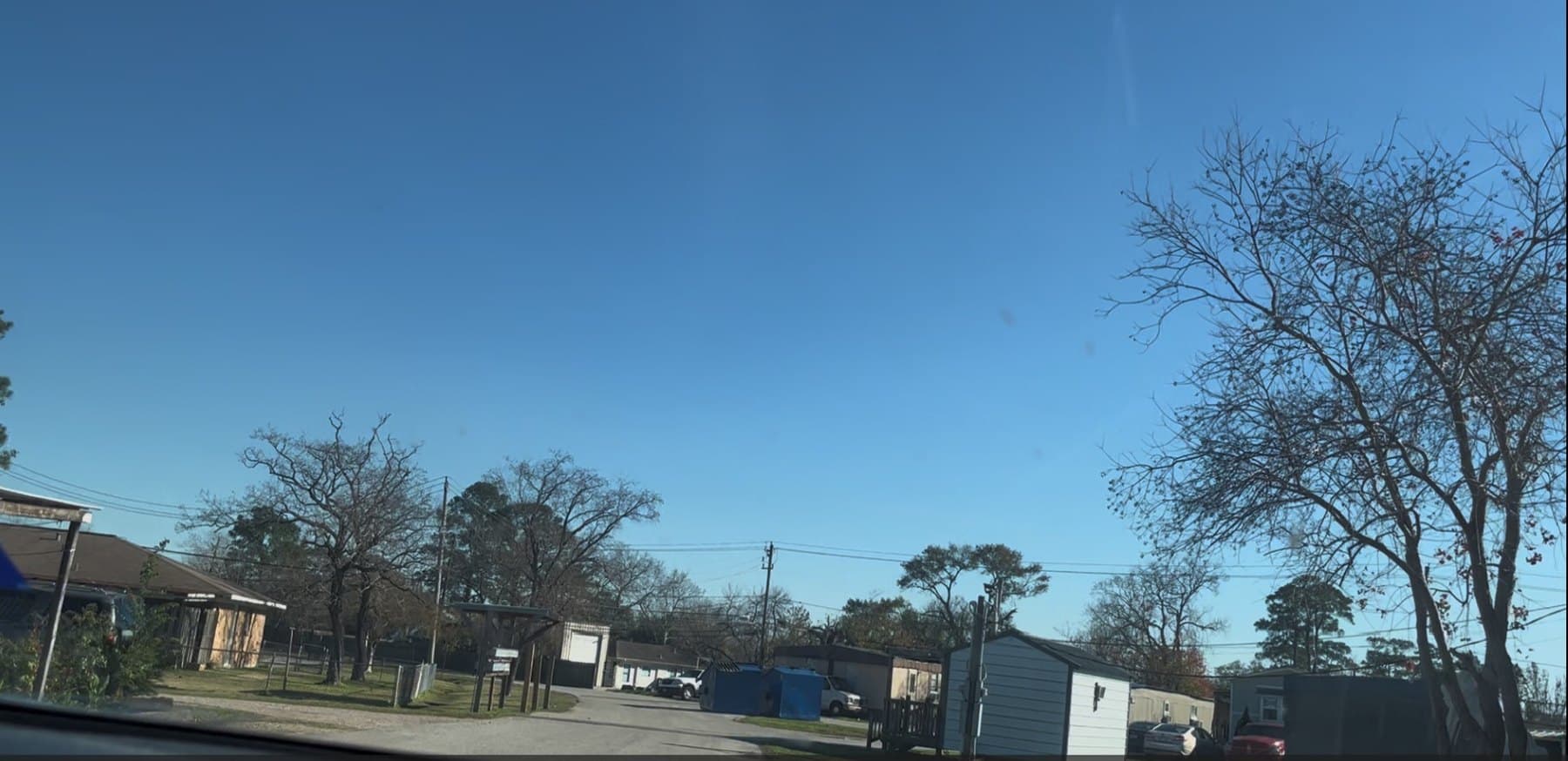 Interior drive through Woodforest Mobile Home Park with homes and trees