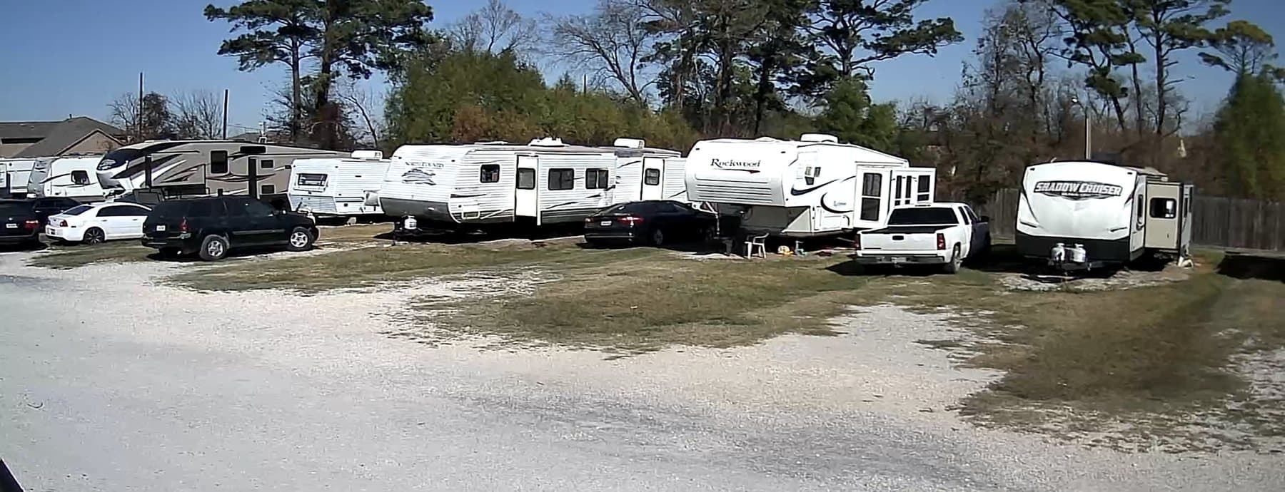 Row of RV spaces with trees behind the park